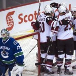 Arizona Coyotes' Tobias Rieder (8) and teammates celebrate his goal against Vancouver Canucks goalie Jacob Markstrom (25) during the second period of an NHL hockey game Wednesday, March 9, 2016, in Vancouver, British Columbia. (Jonathan Hayward/The Canadian Press via AP)