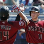 Arizona Diamondbacks' Peter O'Brien (14) celebrates his two-run home run against the San Diego Padres with Chris Herrmann (10) during the second inning of a spring training baseball game Tuesday, March 8, 2016, in Peoria, Ariz. (AP Photo/Ross D. Franklin)
