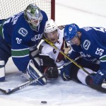 Vancouver Canucks defenseman Alex Biega (55) tries to clear Arizona Coyotes right wing Shane Doan (19) from in front of Canucks goalie Jacob Markstrom (25) during the second period of an NHL hockey game Wednesday, March 9, 2016, in Vancouver, British Columbia. (Jonathan Hayward/The Canadian Press via AP)