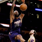 Phoenix Suns center Tyson Chandler, left, dunks over Los Angeles Lakers forward Ryan Kelly during the first half of an NBA basketball game in Los Angeles, Friday, March 18, 2016. (AP Photo/Chris Carlson)