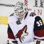 Arizona Coyotes goalie Niklas Treutle, of Germany, stops a shot during the second period of an NHL hockey game against the Calgary Flames, Friday, March 11, 2016, in Calgary, Alberta. (Jeff McIntosh/The Canadian Press via AP) MANDATORY CREDIT