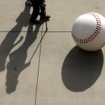 Fans walk past a sculpture of a baseball as they leave the stadium during the seventh inning of a spring training baseball game between the Seattle Mariners and the Arizona Diamondbacks, Monday, March 7, 2016, in Peoria, Ariz. (AP Photo/Charlie Riedel)