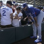 Los Angeles Dodgers right fielder Andre Ethier smiles as he has his photo taken with fan Josh Nungaray before a spring training baseball game between the Arizona Diamondbacks and the Dodgers in Scottsdale, Ariz., Friday, March 18, 2016. (AP Photo/Jeff Chiu)