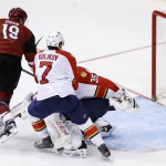 Arizona Coyotes' Shane Doan (19) sends the puck past Florida Panthers' Al Montoya (35) and Dmitry Kulikov (7), of Russia, for a goal during the third period of an NHL hockey game Saturday, March 5, 2016, in Glendale, Ariz. (AP Photo/Ross D. Franklin)