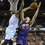 Phoenix Suns center Alex Len, right, of the Ukraine, goes to the basket against Sacramento Kings forward Quincy Acy during the first half of an NBA basketball game Friday, March 25, 2016, in Sacramento, Calif. (AP Photo/Rich Pedroncelli)