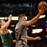 Phoenix Suns forward Mirza Teletovic, right, drives past Boston Celtics center Kelly Olynyk, left, in the second quarter during an NBA basketball game, Saturday, March 26, 2016, in Phoenix. (AP Photo/Rick Scuteri)