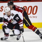 Arizona Coyotes' Shane Doan, left, and Calgary Flames' Lance Bouma chase the puck during the second period of an NHL hockey game, Friday, March 11, 2016, in Calgary, Alberta. (Jeff McIntosh/The Canadian Press via AP) MANDATORY CREDIT