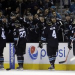 San Jose Sharks' Brenden Dillon (4) celebrates his goal with teammates on the bench during the first period of an NHL hockey game against the Arizona Coyotes Sunday, March 20, 2016, in San Jose, Calif. (AP Photo/Marcio Jose Sanchez)
