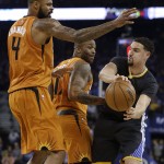 Golden State Warriors' Klay Thompson, right, looks to pass away from Phoenix Suns' Tyson Chandler (4) and P.J. Tucker during the first half of an NBA basketball game Saturday, March 12, 2016, in Oakland, Calif. (AP Photo/Ben Margot)