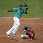 Seattle Mariners second baseman Robinson Cano misses the throw as Arizona Diamondbacks' Brandon Drury (27) steals second during the third inning of a spring training baseball game Monday, March 7, 2016, in Peoria, Ariz. Drury went on to get thrown out trying to advance to third on the overthrow. (AP Photo/Charlie Riedel)