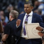 Phoenix Suns coach Earl Watson grabs a clipboard to draw a play as he calls for a timeout during the second half against the Denver Nuggets in an NBA basketball game Thursday, March 10, 2016, in Denver. The Nuggets won 116-98. (AP Photo/David Zalubowski)