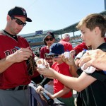 Arizona Diamondbacks' Paul Goldschmidt, left, signs autographs for fans prior to a spring training baseball game against the San Diego Padres Tuesday, March 8, 2016, in Peoria, Ariz. (AP Photo/Ross D. Franklin)