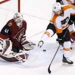Philadelphia Flyers' Ryan White (25) tries to get out of the way of a shot as Arizona Coyotes' Mike Smith (41) moves in to make a save during the third period of an NHL hockey game Saturday, March 26, 2016, in Glendale, Ariz. The Coyotes defeated the Flyers 2-1. (AP Photo/Ross D. Franklin)