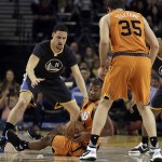 Phoenix Suns' Tyson Chandler, center, looks to pass away from Golden State Warriors' Klay Thompson, left, to Suns' Mirza Teletovic (35) during the first half of an NBA basketball game Saturday, March 12, 2016, in Oakland, Calif. (AP Photo/Ben Margot)