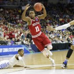 Indiana guard Yogi Ferrell, center, drives between Kentucky's Tyler Ulis, left, and Skal Labissiere, right, during the first half of a second-round men's college basketball game in the NCAA Tournament, Saturday, March 19, 2016, in Des Moines, Iowa. (AP Photo/Charlie Neibergall)