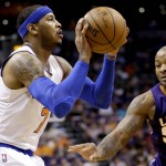 New York Knicks' Carmelo Anthony shoots as Phoenix Suns' P.J. Tucker defends during the first half of an NBA basketball game, Wednesday, March 9, 2016, in Phoenix. (AP Photo/Matt York)