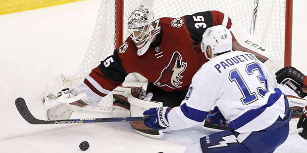Arizona Coyotes' Louis Domingue (35) makes a save on a shot by Tampa Bay Lightning's Cedric Paquett...