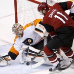 Philadelphia Flyers' Steve Mason, left, makes a save on a shot by Arizona Coyotes' Martin Hanzal (11), of the Czech Republic, during the first period of an NHL hockey game Saturday, March 26, 2016, in Glendale, Ariz. (AP Photo/Ross D. Franklin)