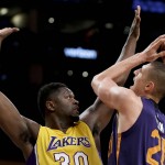 Phoenix Suns center Alex Len, right, shoots over Los Angeles Lakers forward Julius Randle during the first half of an NBA basketball game in Los Angeles, Friday, March 18, 2016. (AP Photo/Chris Carlson)