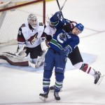 Arizona Coyotes defenseman Connor Murphy (5) tries to clear Vancouver Canucks center Brendan Gaunce (50) from in front of goalie Louis Domingue (35) during the third period of an NHL hockey game Wednesday, March 9, 2016, in Vancouver, British Columbia. (Jonathan Hayward/The Canadian Press via AP) MANDATORY CREDIT