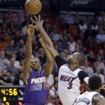 Phoenix Suns guard Ronnie Price (14) shoots as Miami Heat guard Dwyane Wade (3) defends during the first half of an NBA basketball game, Thursday, March 3, 2016, in Miami. (AP Photo/Alan Diaz)