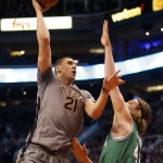 Phoenix Suns center Alex Len, left, shoots over Boston Celtics center Kelly Olynyk, right, in the second quarter during an NBA basketball game, Saturday, March 26, 2016, in Phoenix. (AP Photo/Rick Scuteri)