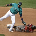 Seattle Mariners second baseman Robinson Cano tags Arizona Diamondbacks' Jason Bourgeois as he tries to steal second during the fourth inning of a spring training baseball game, Monday, March 7, 2016, in Peoria, Ariz. (AP Photo/Charlie Riedel)