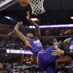 Phoenix Suns guard Archie Goodwin, center, collides with Suns center Tyson Chandler, right, after being fouled by Memphis Grizzlies forward Matt Barnes, left, in the first half of an NBA basketball game Sunday, March 6, 2016, in Memphis, Tenn. (AP Photo/Brandon Dill)