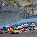 Drivers Kyle Busch, left, and Carl Edwards, right, lead the pack at the start of a NASCAR Sprint Cup Series auto race at Phoenix International Raceway, Sunday, March 13, 2016, in Avondale, Ariz. (AP Photo/Ross D. Franklin)