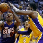 Phoenix Suns forward P.J. Tucker (17) drives as Los Angeles Lakers center Roy Hibbert, right, defends during the second half of an NBA basketball game Wednesday, March 23, 2016, in Phoenix. The Suns won 119-107. (AP Photo/Matt York)