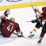 Arizona Coyotes' Mike Smith (41) makes a save on a shot by Philadelphia Flyers' Wayne Simmonds (17) as Coyotes' Zbynek Michalek (4), of the Czech Republic, defends on the play during the first period of an NHL hockey game Saturday, March 26, 2016, in Glendale, Ariz. (AP Photo/Ross D. Franklin)