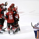 Arizona Coyotes' Martin Hanzal (11), of the Czech Republic, celebrates his goal with Max Domi (16), Michael Stone (26), Anthony Duclair, and Oliver Ekman-Larsson, second from left, of Sweden, as Edmonton Oilers' Anton Lander (51), of Sweden, skates past during the second period of an NHL hockey game, Tuesday, March 22, 2016, in Glendale, Ariz. (AP Photo/Ross D. Franklin)