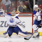 Edmonton Oilers' Cam Talbot, left, makes a save on a shot by Arizona Coyotes' Jiri Sekac, of the Czech Republic, as Oilers' Mark Fayne (5) defends during the first period of an NHL hockey game, Tuesday, March 22, 2016, in Glendale, Ariz. (AP Photo/Ross D. Franklin)