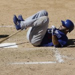 Los Angeles Dodgers' Andre Ethier rolls on the ground during the fourth inning of a spring training baseball game against the Arizona Diamondbacks in Scottsdale, Ariz., Friday, March 18, 2016. Ethier left the game after reaching first base on a walk. (AP Photo/Jeff Chiu)