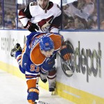 Arizona Coyotes' Tobias Rieder (8) trips up Edmonton Oilers' Ryan Nugent-Hopkins (93) during the first period of an NHL hockey game in Edmonton, Alberta, Saturday, March 12, 2016. (Jason Franson/The Canadian Press via AP) MANDATORY CREDIT