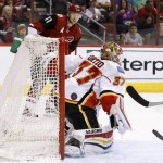 Calgary Flames' Joni Ortio (37), of Finland, gives up a goal to Arizona Coyotes' Anthony Duclair after getting a pass from Coyotes' Martin Hanzal (11), of the Czech Republic, during the second period of an NHL hockey game Monday, March 28, 2016, in Glendale, Ariz. (AP Photo/Ross D. Franklin)