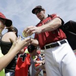 Arizona Diamondbacks first baseman Paul Goldschmidt, right, signs autographs for fans before a spring training baseball game between the Diamondbacks and the Seattle Mariners in Scottsdale, Ariz., Monday, March 14, 2016. (AP Photo/Jeff Chiu)