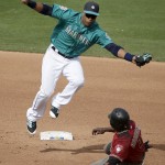 Seattle Mariners second baseman Robinson Cano tags Arizona Diamondbacks' Jason Bourgeois as he tries to steal second during the fourth inning of a spring training baseball game, Monday, March 7, 2016, in Peoria, Ariz. (AP Photo/Charlie Riedel)