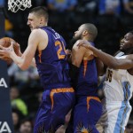 Phoenix Suns center Alex Len, left, of the Ukraine, pulls in a rebound in front of center Tyson Chandler and Denver Nuggets forward Kenneth Faried, right, in the first half of an NBA basketball game Thursday, March 10, 2016, in Denver. (AP Photo/David Zalubowski)