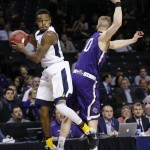 West Virginia's Daxter Miles Jr. (4) looks to pass away from Stephen F. Austin's Thomas Walkup (0) before landing out of bounds during the first half of a first-round men's college basketball game in the NCAA Tournament,Friday, March 18, 2016, in New York. (AP Photo/Frank Franklin II)