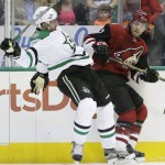 Arizona Coyotes left wing Eric Selleck (42) knocks Dallas Stars defenseman Patrik Nemeth (15) off balance during the first period of an NHL hockey game Thursday, March 31, 2016, in Dallas. (AP Photo/LM Otero)