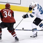 San Jose Sharks' Logan Couture (39) tries to get off a pass as Arizona Coyotes' Klas Dahlbeck (34), of Sweden, defends during the third period of an NHL hockey game Thursday, March 17, 2016, in Glendale, Ariz. The Coyotes defeated the Sharks 3-1. (AP Photo/Ross D. Franklin)