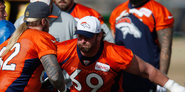 Denver Broncos guard Evan Mathis, right, squares off with practice squad center Dillon Day during a...
