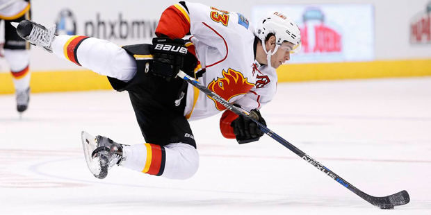 Calgary Flames' Sean Monahan falls to the ice after trying to change direction and keep control of ...
