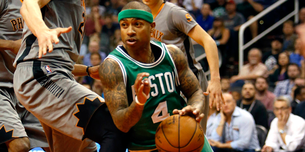 Boston Celtics guard Isaiah Thomas, right, drives past Phoenix Suns center Alex Len, left, in the t...