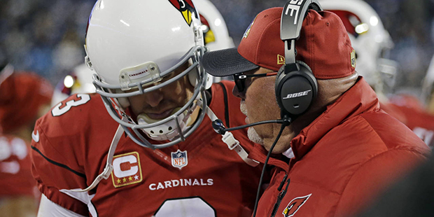 Arizona Cardinals head coach Bruce Arians talks to Carson Palmer during the second half the NFL foo...