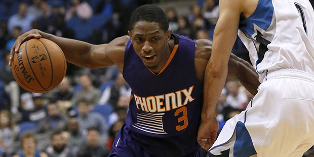 Phoenix Suns guard Brandon Knight (3) drives against Minnesota Timberwolves guard Ricky Rubio (9), ...