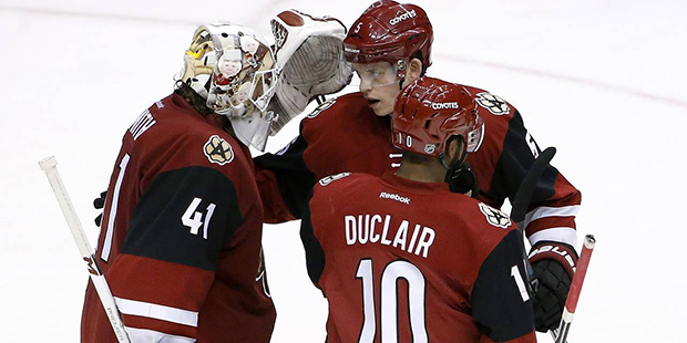Arizona Coyotes' Mike Smith (41) celebrates a win against the Philadelphia Flyers with Anthony Ducl...