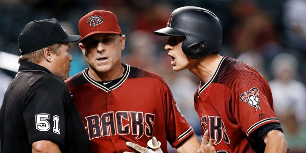 Arizona Diamondbacks' Nick Ahmed, right, argues a called third strike after being ejected by umpire...