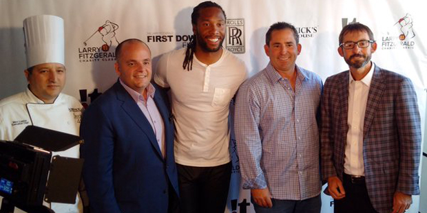Larry Fitzgerald poses with the crew from Dominick's Steakhouse Thursday, April 21. (Photo from @La...